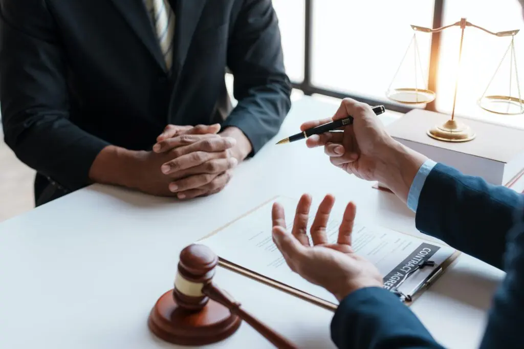 Lawyer and client sign variou financial legal contract to mediate with the legal execution